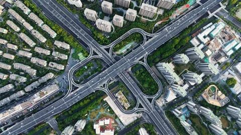 Aerial top down view of a complex junction with multiple lanes and green spaces Stock Footage 308837289