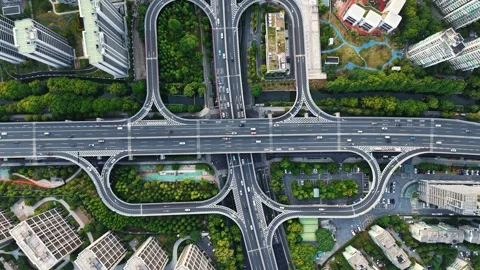 Aerial top down view of a complex junction with multiple lanes and green spaces Stock Footage 311559043