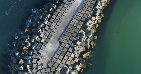 Aerial top down view of concrete breakwater and speeding boat The Concept o.. Stock-Footage 327582614