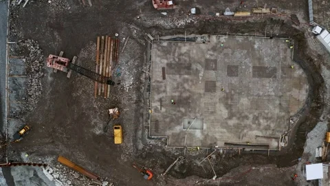 Aerial top down view of construction site with excavators and dump trucks during Stock Footage 263060501