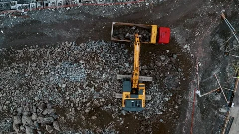 Aerial top down view of construction site with excavator and dump trucks during Stock Footage 263060606