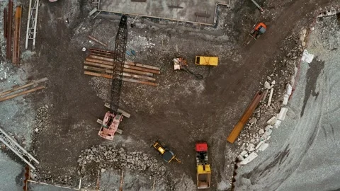 Aerial top down view of construction site with excavators and dump trucks during Stock Footage 269048379