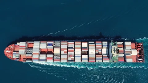 Aerial top down view of a container ship. Her engine roaring at full speed Video stock 129178672