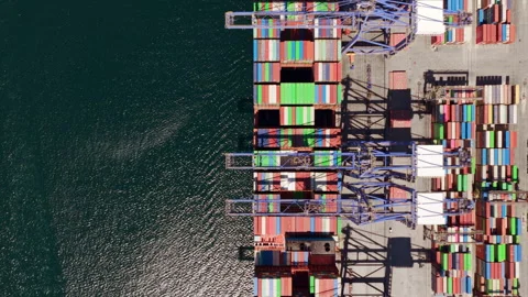 Aerial top down view of container ship leaving commercial port Stock Footage 345007222