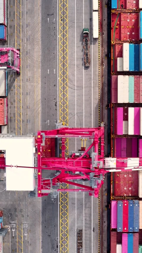 Aerial top down view of crane loading containers onto a cargo ship Stock Footage 340581791