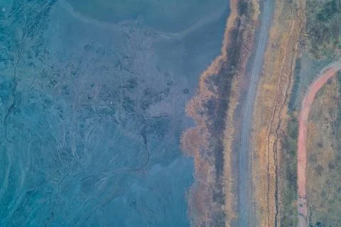 Aerial top down view of crashed Russian Molniya UAV on dried industrial pond Stock Photos