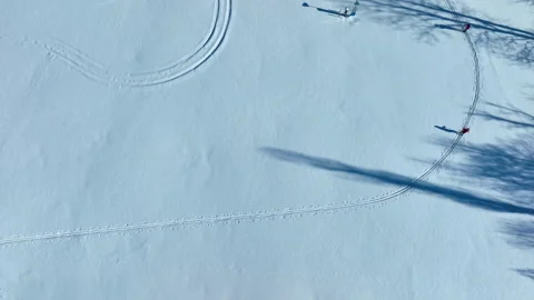 Aerial Top Down View Of Cross Country Skiers On Snowy Track Stock Footage 330983137