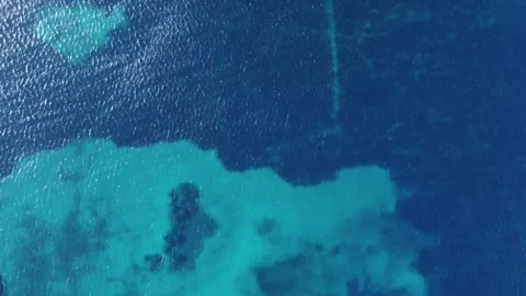Aerial Top-Down View of Crystal Clear Turquoise Sea with Gentle Rippling Waves Video stock 298977641