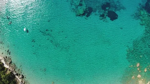 Aerial Top Down View of Crystal Clear Turquoise Sea, Rocky Reef and Boat Stock-Footage 331083892