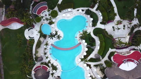 Aerial top down view of curved pool with clear transparent blue water and green Video stock 236310033