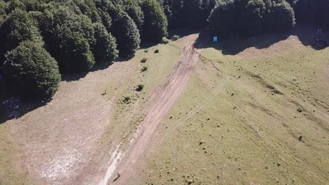 Aerial top down view, Cyclist in a sunny morning, ride in an open mountain valle Stock Footage 113040584