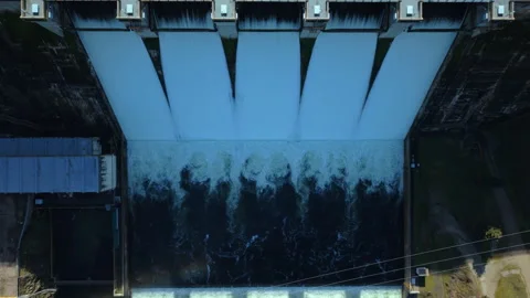 Aerial top down view of a dam releasing massive amounts of water Video stock 328356055