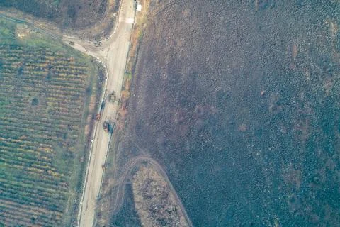 Aerial top down view of destroyed military equipment on road intersection near Stock Photos