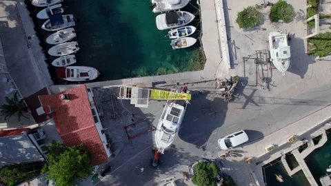Aerial top down view of dinghy launch the boat by crane at a pier Stock Footage 204150467