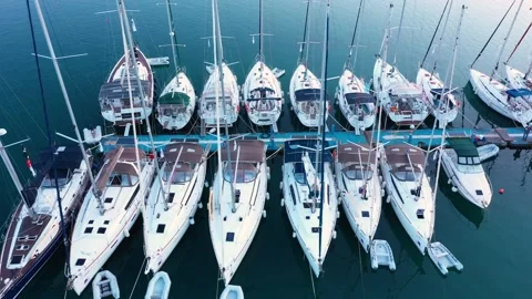 Aerial top-down view of docked sailboats.  Top down view of yachts in the marina Video stock 203812662