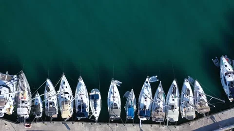 Aerial top-down view of docked sailboats.  Top down view of yachts in the marina Video stock 203814740