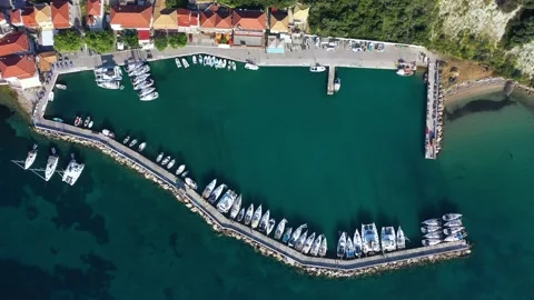 Aerial top-down view of docked sailboats.  Top down view of yachts in the marina Video stock 203815635