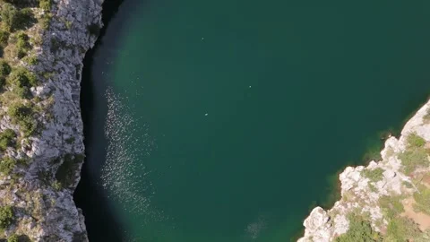 Aerial top down view Dragon Eye Lake green water, cliffs ft. bird near Rogoznica 動画素材 337194967