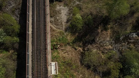 Aerial top down view; drone moving over the old railway bridge Stock Footage 109330870