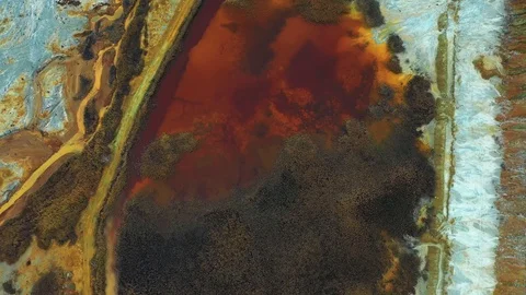 Aerial top down view; drone flying over a very polluted river with copper Stock Footage 118252793