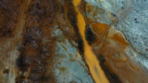 Aerial top down view; drone flying over a very polluted river with copper Stock Footage 118281192