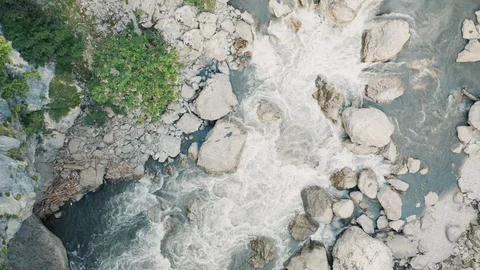 Aerial top down view; drone flying over stormy river Stock Footage 118295492