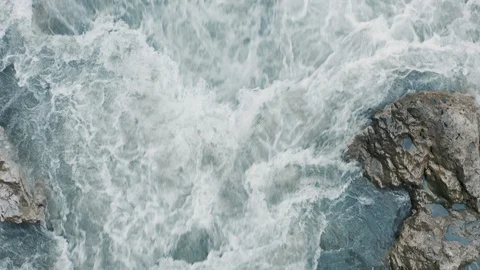 Aerial top down view; drone flying over stormy river Stock Footage 118296611