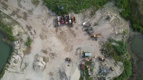 Aerial top down view of dump trucks and bulldozers in a large sand quarry Stockbeeldmateriaal 347864487