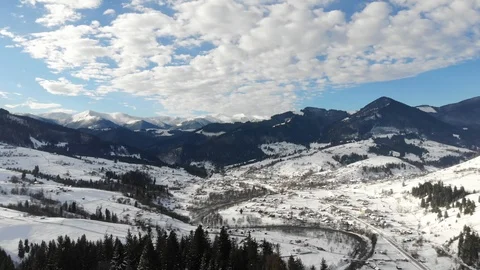 Aerial - Top down view of empty road between the snowy pine trees Stock Footage 126245162