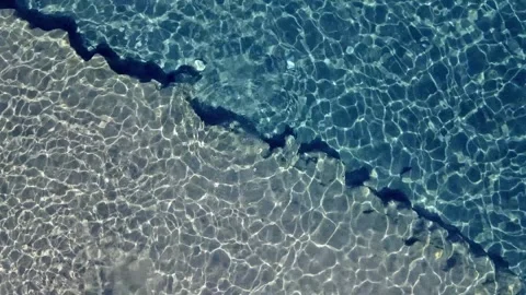 Aerial Top-Down View of Empty Beach and Turquoise Sea Stock Footage 305260054