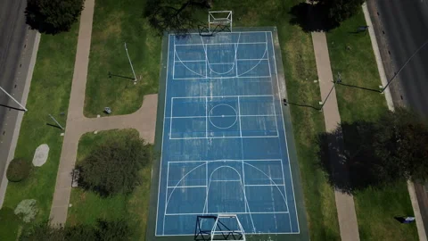 Aerial top down view of empty blue multipurpose sports court in green park Vídeos de archivo 345618115