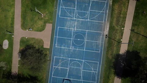 Aerial top down view of empty blue multipurpose sports court in green park Stock-Footage 345618129