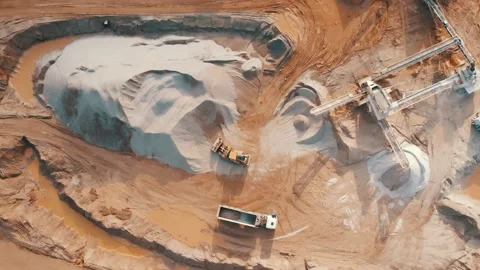 Aerial top down view of excavator loading crushed stone into truck in crushed Video stock 237265989