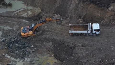 Aerial top down view of an excavator loading dump truck Stock Footage 335118789