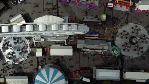 Aerial top down view of fair showing several funfair attractions 4k Stock Footage 236714464