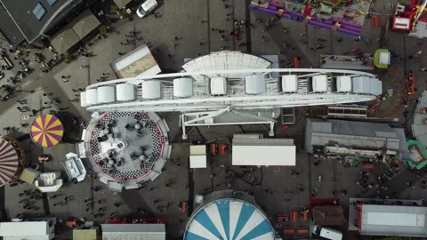 Aerial top down view of fair showing funfair attractions like ferris wheel Stock Footage 262146400
