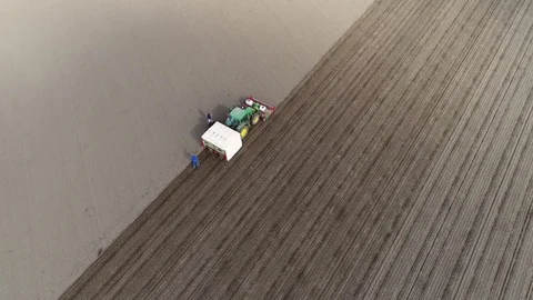 Aerial top-down view flight above soil field showing GPS driven tractor 4k Stock Footage 81885126