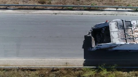 Aerial top-down view flight over road then garbage truck takes over 4k Stock Footage 83460149