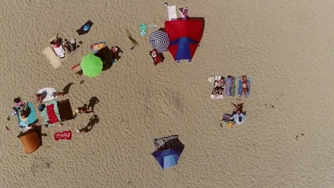 Aerial top down view flight over recreational beach with many people 4k Stock Footage 85279439