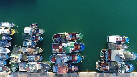 Aerial top down view flight to right over mediterranean fishing harbor Stock Footage 87289540