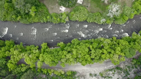 Aerial top down view of flooded Provo River from excess snow moving with current 스톡 동영상 248174615