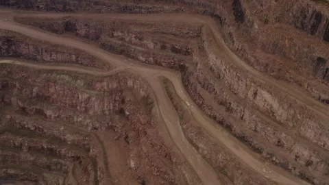 Aerial top down view fly over deep quarry earth ground layers and gravel road Video stock 251040832