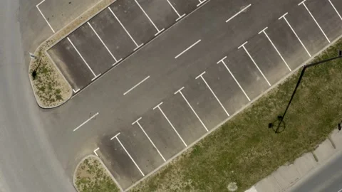 Aerial top down view flying above empty parking lot due to Covid Stock Footage 161474710