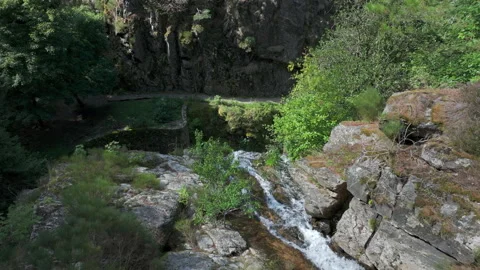 Aerial top-down view flying forward over the edge of a mountain waterfall droppi Stock-Footage 333050607