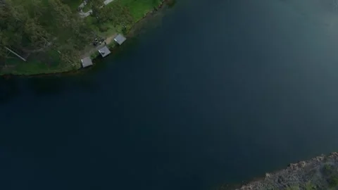 Aerial top down view flying over a tranquil lake shore Stock Footage 339376551