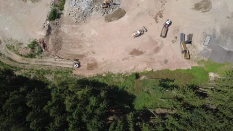 Aerial top down view flying from forest over a construction site Vídeo Stock 340455849