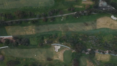 Aerial top-down view flying over a green golf course 스톡 동영상 342575120
