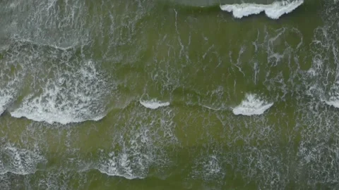 Aerial Top Down View of Foamy Waves Crashing on a Sandy Beach in Lithuania (Balt Stock Footage 321752984