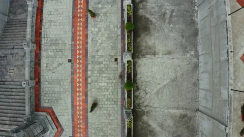Aerial top down view, following an wall around a roman catolic church Stock Footage 146344161