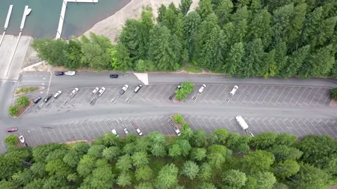 Aerial top down view following an SUV with boat trailer at the lake. Stock Footage 149339538
